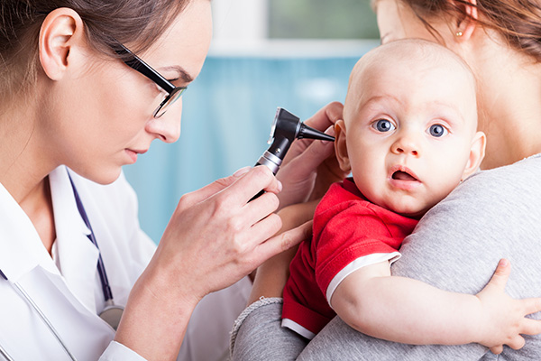 A doctor examining a baby