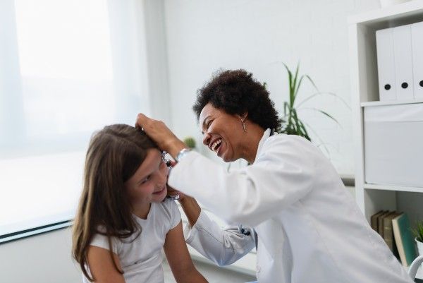 A nurse examining a patient's ear